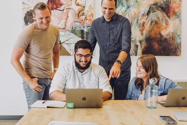 An illustration showcasing a diverse group of people, representing developers, designers, documentation writers, and other contributors working together on an open-source project. This image highlights the collaborative nature of open-source communities.